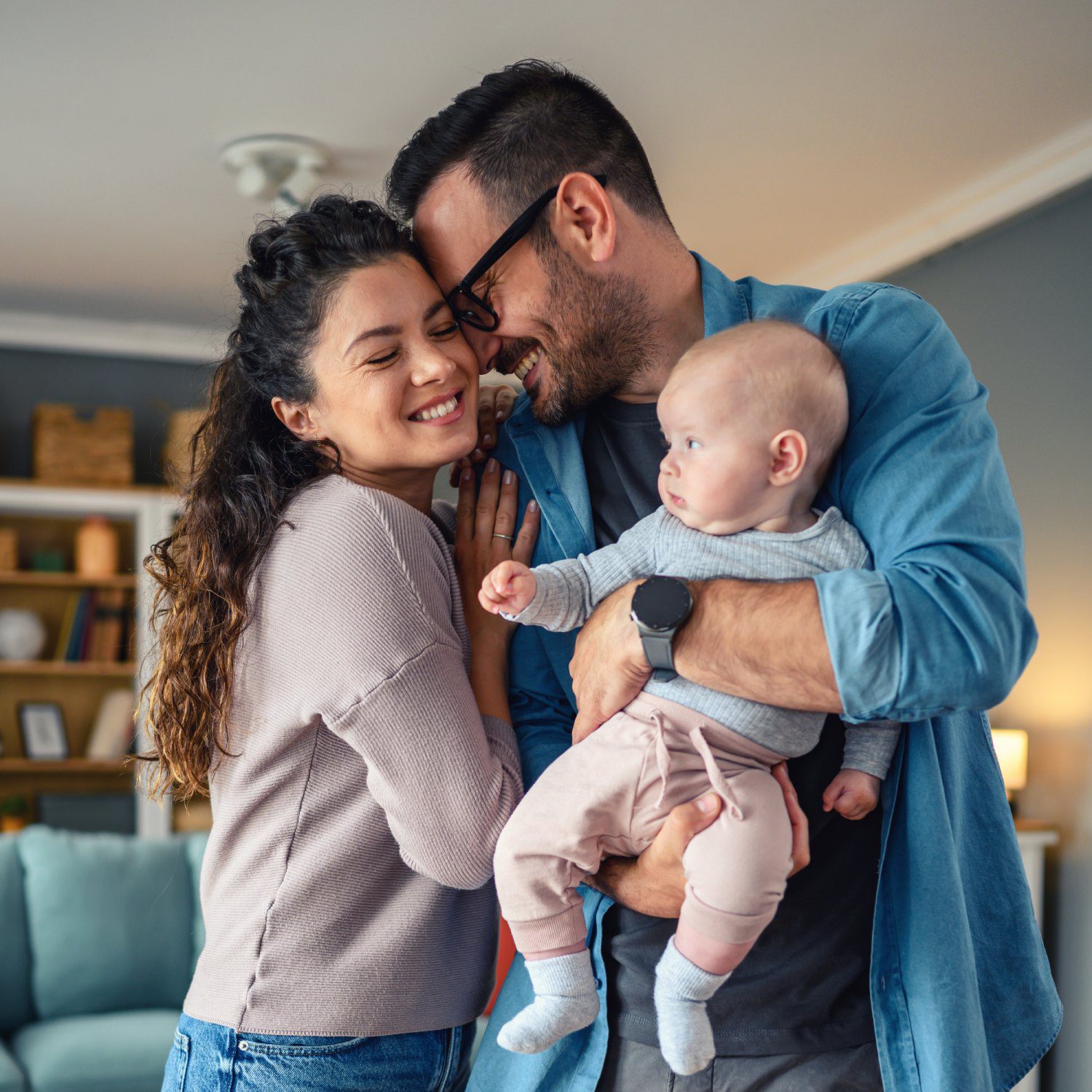 Happy family with baby at home.