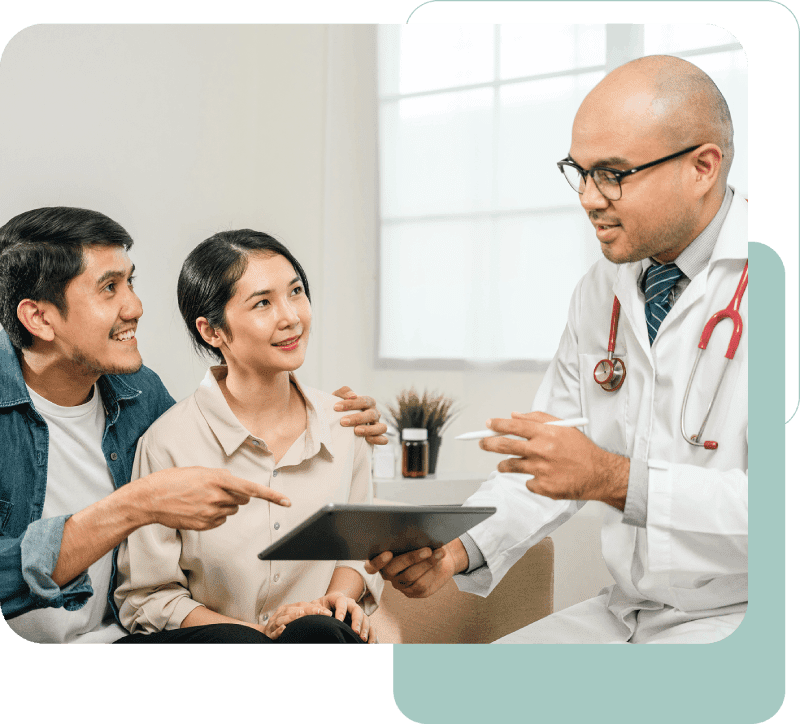 Doctor consulting couple with a tablet.